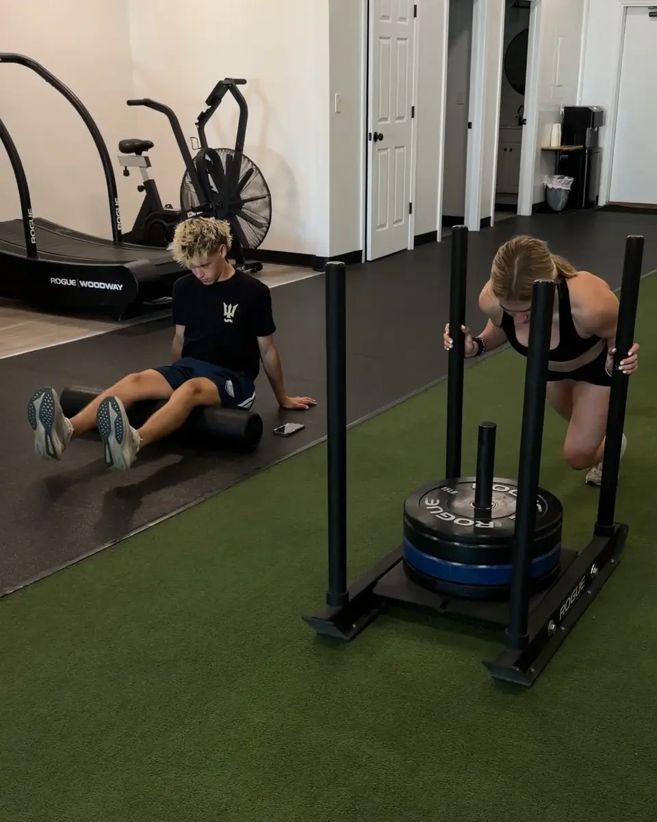 Athletes completing sled and recovery work in a coached session in Glastonbury, CT